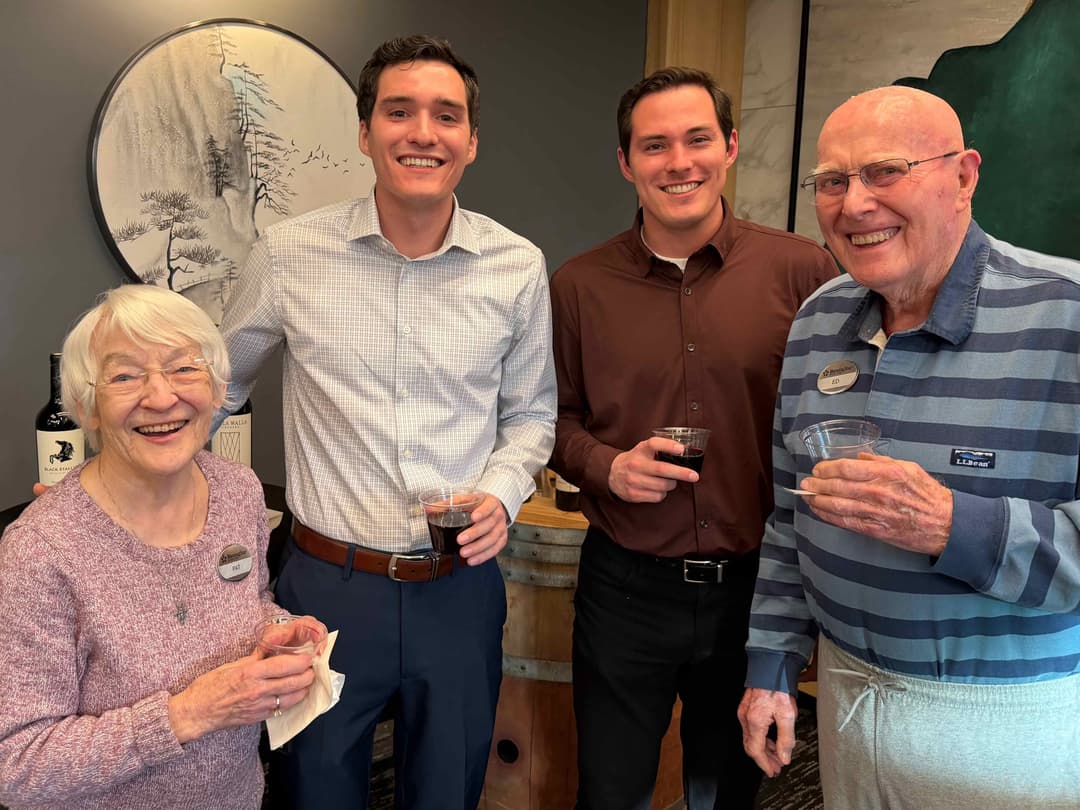 The Care Brothers and community members celebrating together, showing genuine intergenerational joy and connection